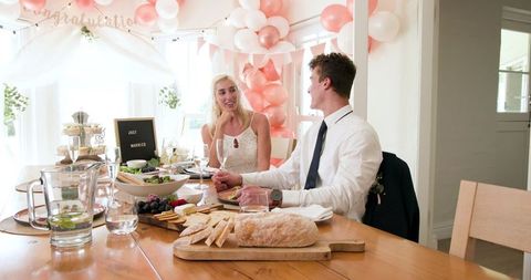 Newlywed couple celebrating with friends in cozy setting