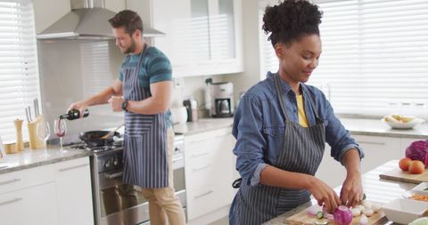 Happy Diverse Couple Cooking Together in Modern Kitchen