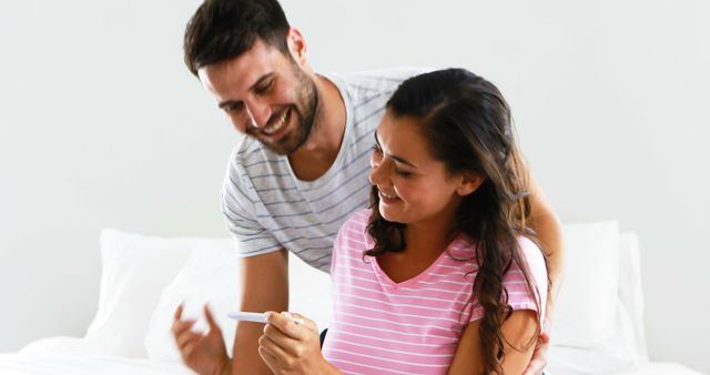 Couple Smiling While Looking at Pregnancy Test - Download Free Stock Images Pikwizard.com