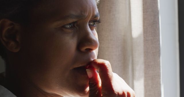 Worried Woman Deep in Thought by Window with Natural Light - Download Free Stock Images Pikwizard.com