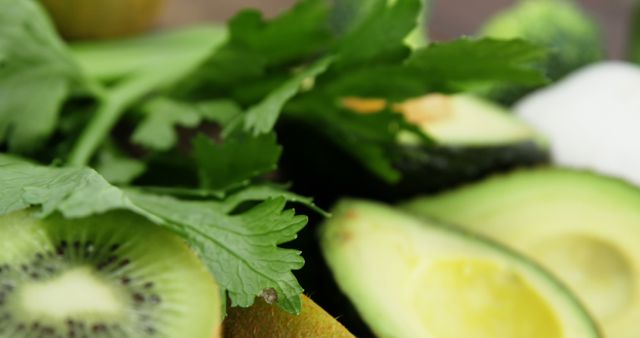 Fresh kiwi, celery, and avocado mix releases essence of healthy eating and nutrition. Ideal for articles on plant-based diets, organic foods, or clean eating recipes. Bright greens make it visually appealing for cooking blogs or healthy lifestyle related use.