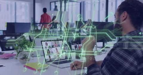 Bearded Man Adjusting Desk Lamp During Virtual Meeting with Futuristic Circuit Overlay