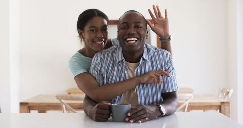 Joyful Young Couple Embracing at Bright Home