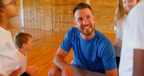 Caucasian Coach Engaging with Schoolchildren in Gym