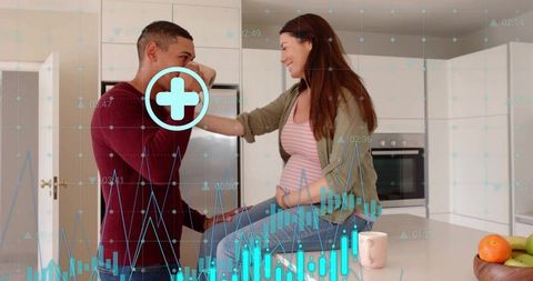 Pregnant couple sharing tender kiss on kitchen island with digital health charts overlay