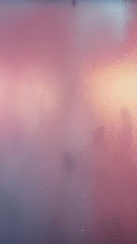 Vertical Shower Silhouette Through Frosted Glass with Warm Backlight and Dripping Water