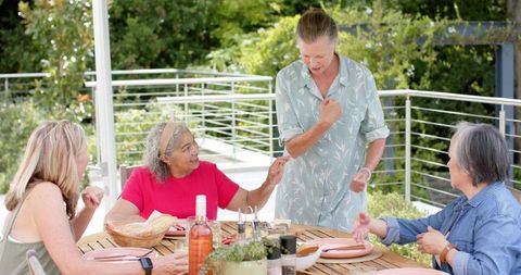 Happy Friends Having Lunch Outdoors on Sunny Day