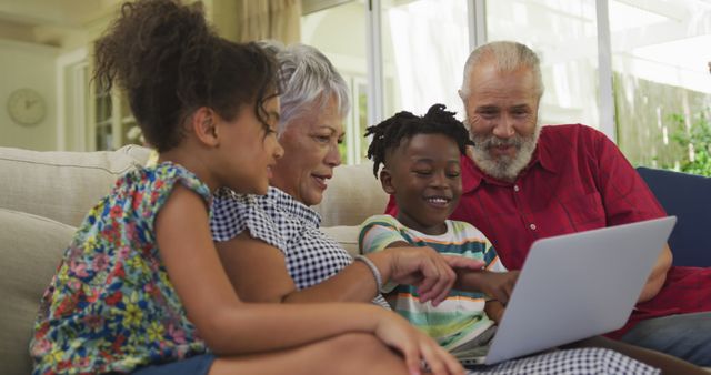 Diverse Family Bonding Over Laptop on Couch at Home - Download Free Stock Images Pikwizard.com