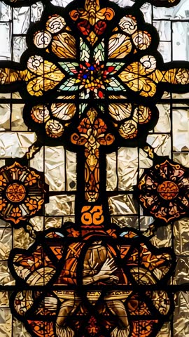 Tilting vertical video revealing stained glass rosette cross and robed figure in chapel