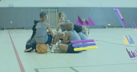 Youth basketball team huddling on gym court listening to teammate with live data overlays