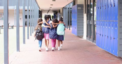 Group of School Children Walking Together in Hallway Holding Backpacks - Download Free Stock Images Pikwizard.com