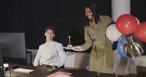 Late-night office celebration with colleagues and cake