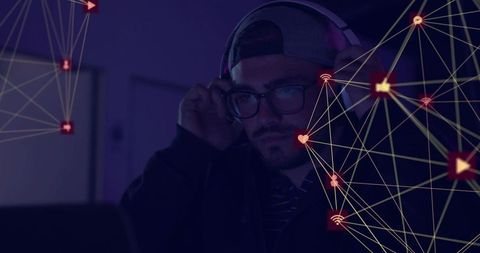 Bearded man adjusting headset in late-night studio with laptop and neon network overlay