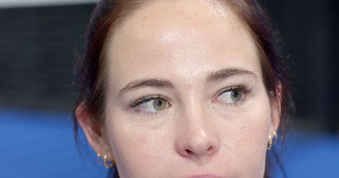 Elegant woman with gold hoop earrings, sophisticated gaze