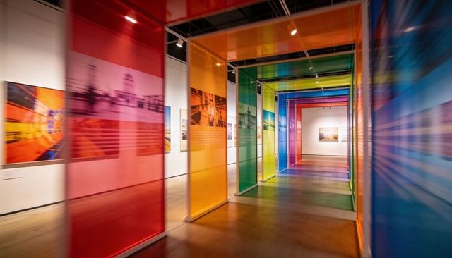 Forming rainbow corridor of translucent panels in contemporary art gallery