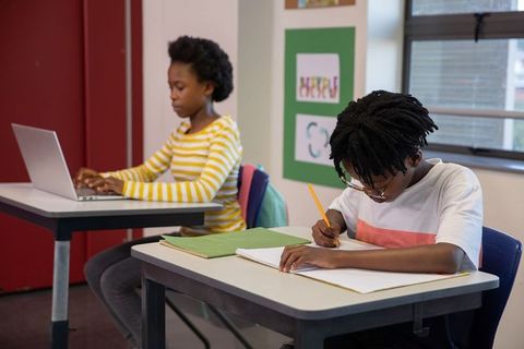Afro-American Teenagers Engaged in Classroom Studies