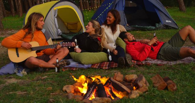 Friends Enjoying Campfire with Guitar and Drinks at Campsite - Download Free Stock Images Pikwizard.com