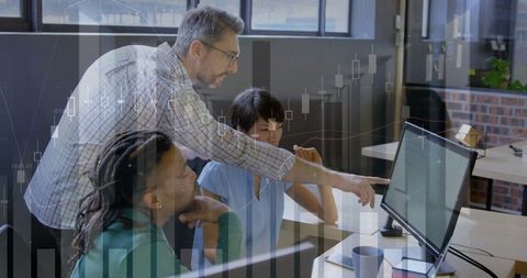 Senior professional guiding team with technology in open-plan office