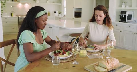 Diverse Friends Enjoying Homemade Meal in Modern Kitchen