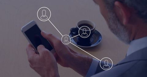 Senior businessman holding smartphone and espresso with digital network overlay