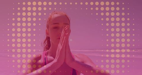 Woman Meditating with Hands in Prayer Pose on Sunny Beach