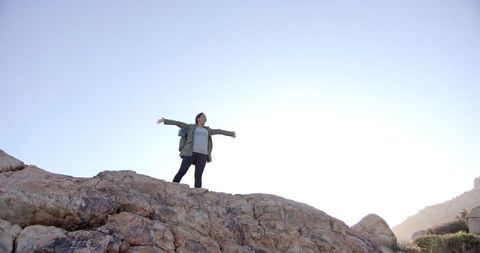 Woman Embracing Nature Landscape on Rocky Mountain Summit