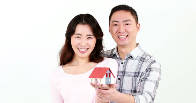 Happy Asian Couple Holding Small House Model - Download Free Stock Images Pikwizard.com