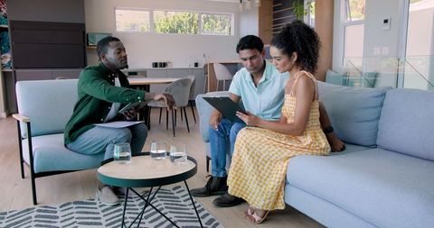 Financial advisor discussing investments with couple at home
