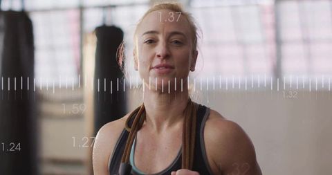 Fit Woman in Warehouse Gym with Jump Rope and Punching Bag