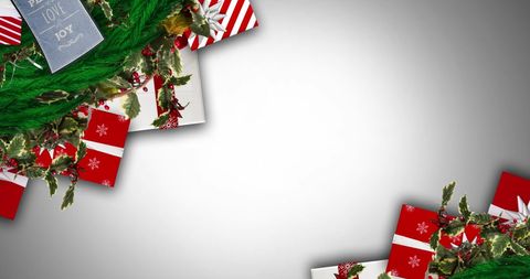 Festive Christmas Gifts and Greenery Against Gray Background