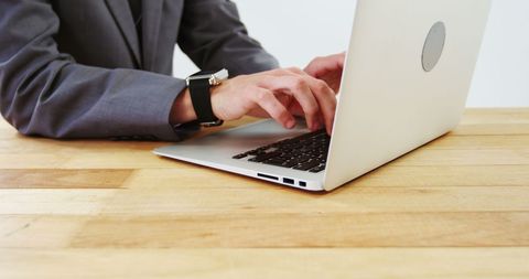 businessman typing on laptop in office environment - Download Free Stock Images Pikwizard.com