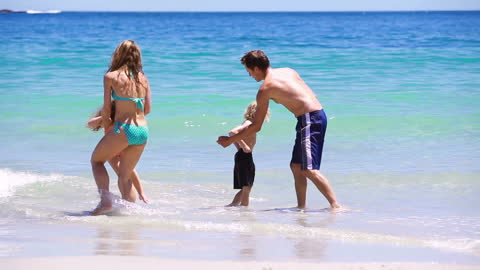 Happy Family Playing on Sandy Beach at Seaside