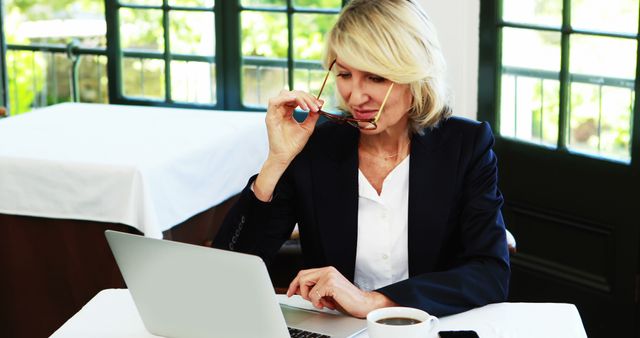 Professional Businesswoman Working on Laptop in Modern Office - Download Free Stock Images Pikwizard.com