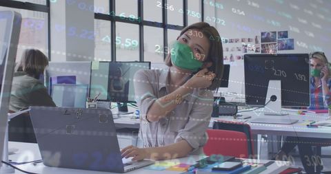 Businesswoman Removing Mask in Cutting-edge Office with Digital Overlay