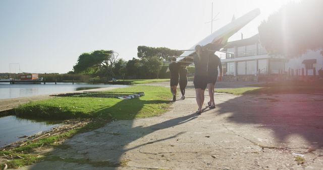 Team Carrying Rowing Boat along Riverbank at Sunrise - Download Free Stock Images Pikwizard.com