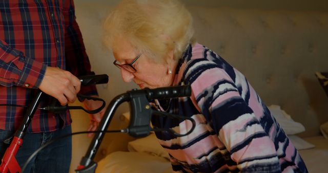 Elderly Woman Receiving Assistance with Walker by Caregiver - Download Free Stock Images Pikwizard.com