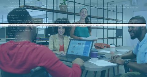 Presenting team collaborating around meeting table with laptop showing code and charts