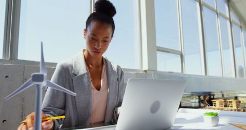 Focused African American Businesswoman Using Laptop in Bright Modern Office