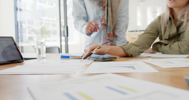 Team Discussing Business Charts and Financial Reports in Bright Office - Download Free Stock Images Pikwizard.com