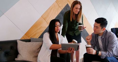 Business Team Discussing Work Using Tablet