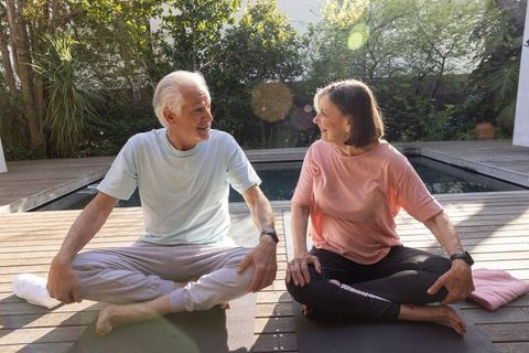 Senior Couple Practicing Relaxation by Plunge Pool