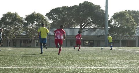 Energetic Youth Soccer Match in Sunny Outdoor Field