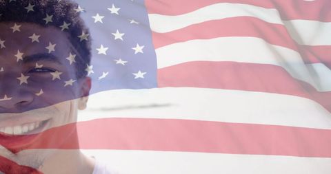 Patriotic spirit with smiling biracial man and american flag