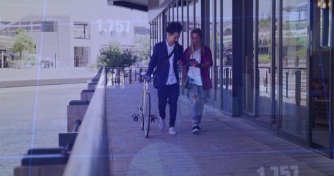 Walking friends sharing smartphone on urban riverside with bicycle and glass reflections