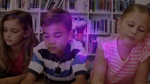 Diverse Schoolchildren Engaged in Reading with Digital Interface Text Overlay