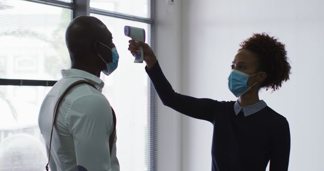 Healthcare Worker Taking Temperature of Man in Face Mask - Download Free Stock Images Pikwizard.com