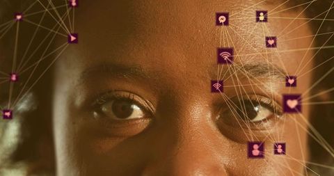 Mid adult woman gazing through augmented reality overlay with purple network icons