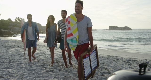 Group of Friends Walking on Beach with Surfboards and Beach Gear - Download Free Stock Images Pikwizard.com