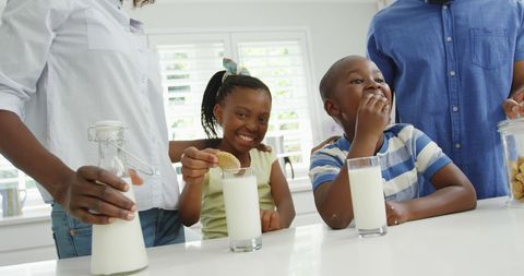 Joyful Family Time with Cookies and Milk in Kitchen - Download Free Stock Images Pikwizard.com