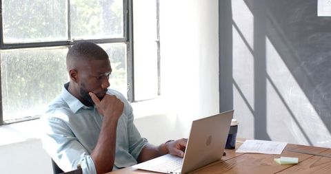 Focused Business Professional Analyzing at Workspace with Documents